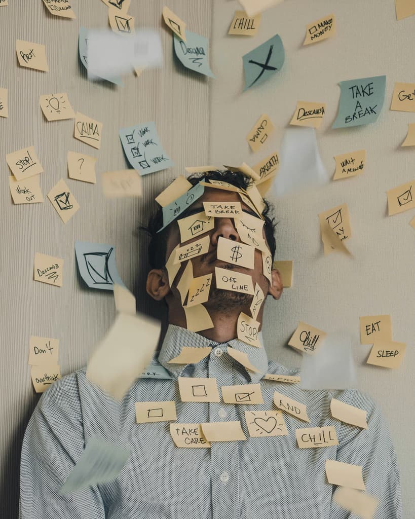 a lot of stickers, some of which are stuck to a man's face' who seems tired from all the work he has done